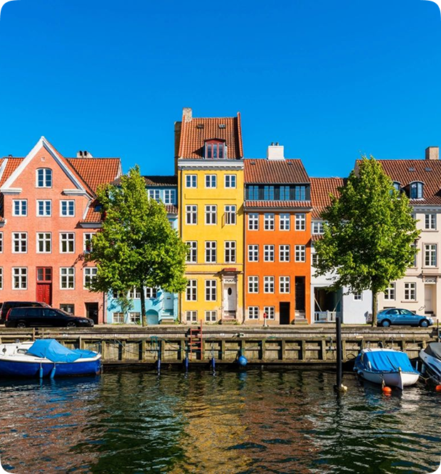 Colorful buildings along a waterfront with boats docked nearby.